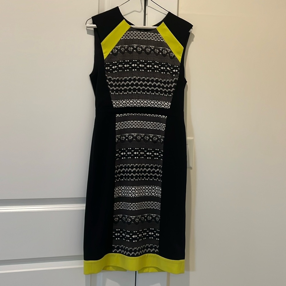 BCBGMAXAZRIA A black dress with yellow trim has lining.   A nice dress.
